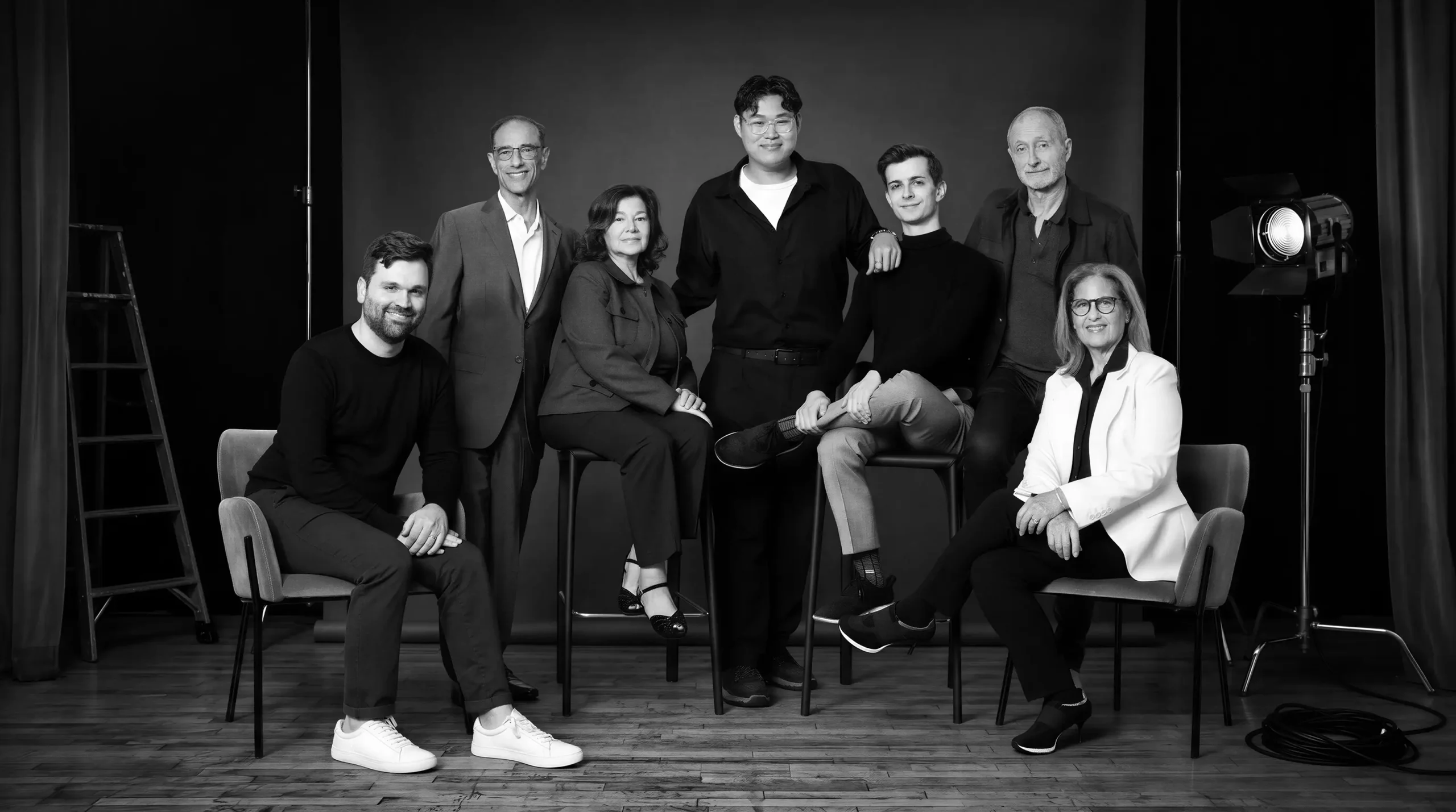 Black-and-white group photograph of the Halcyon Theatricals team in a studio. From left: Kevin Connor, Hal Luftig, Ruth Pomerance, Brandon Doan, Eli Cohen, Kelly Robinson, Cathy Dantchik